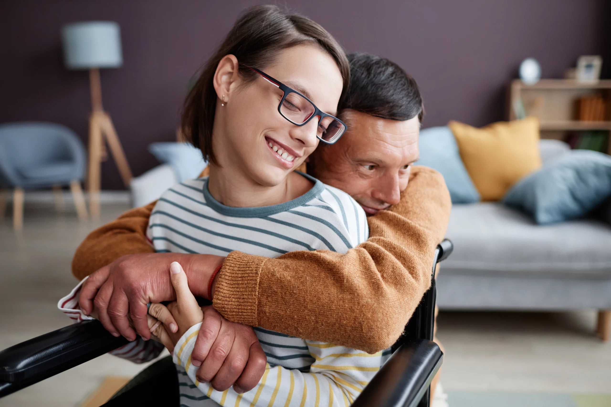 Smiling woman in wheelchair with supportive partner, representing special needs trust protection